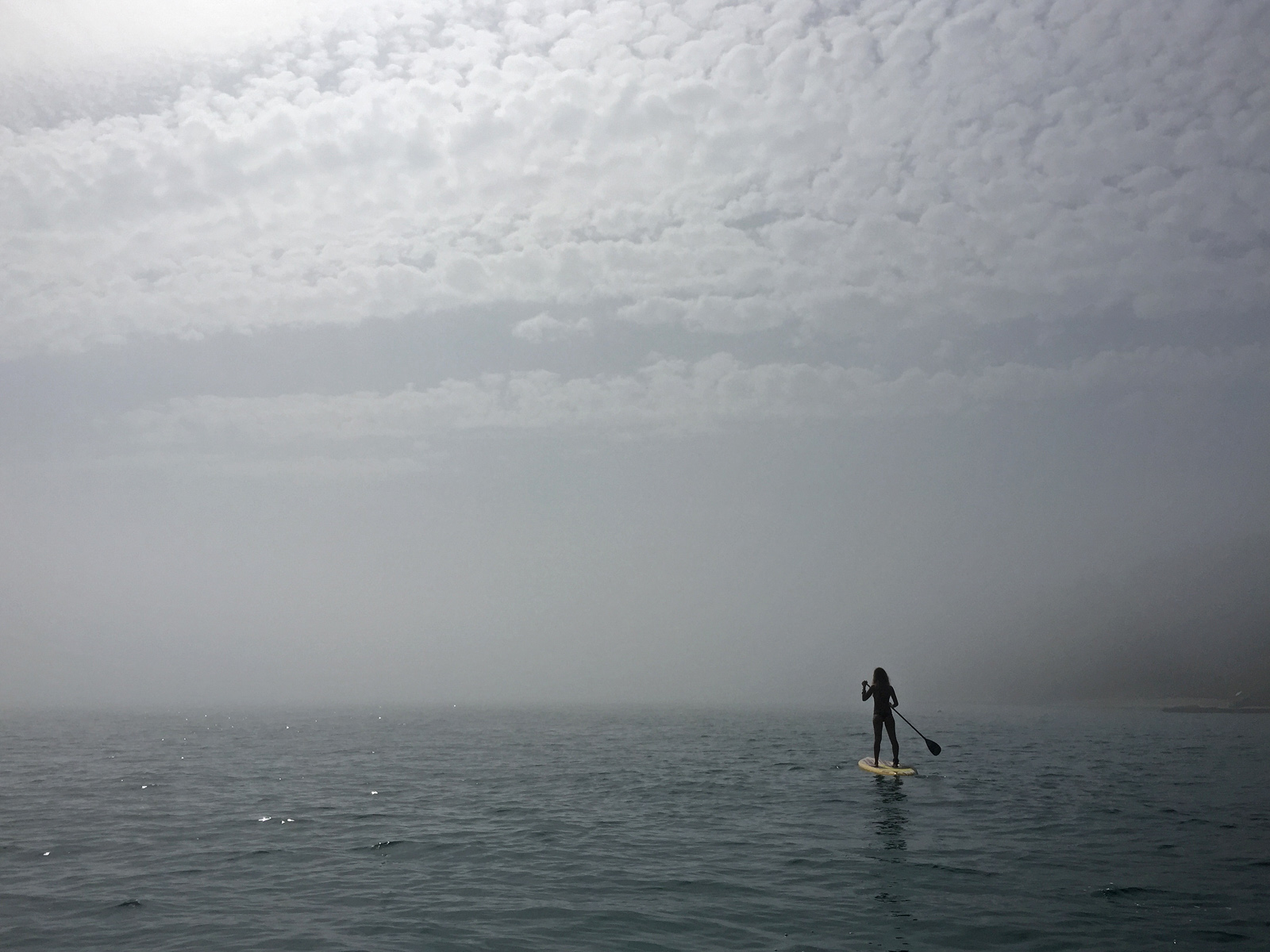 Paddleboarding in dense fog